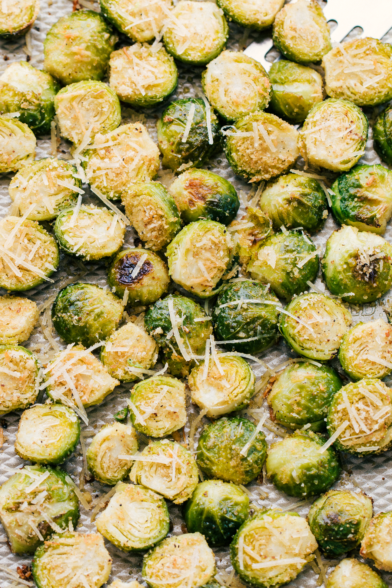 garlic parmesan roasted brussels sprouts on a sheet pan just baked in the oven-delicious side dish. 