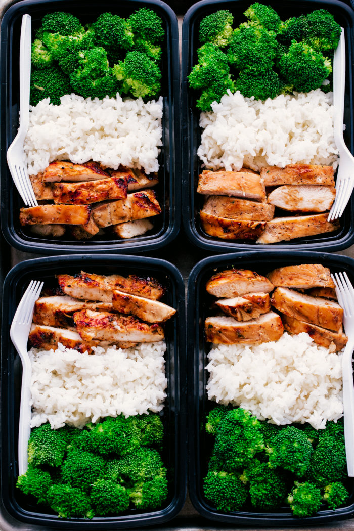 Teriyaki chicken meal prep in black containers served with white rice and steamed broccoli, simple and healthy by The Food Cafe. 