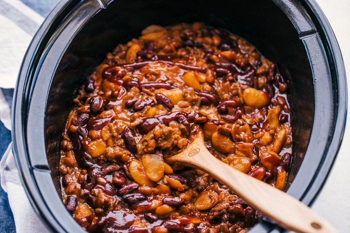 Baked beans made in a black slow cooker for all your cookout needs, by The Food Cafe. 