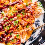 BBQ chicken and mashed potato skillet with gold fork in skillet