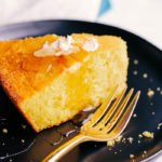 The best skillet cornbread sliced on a plate with butter and honey