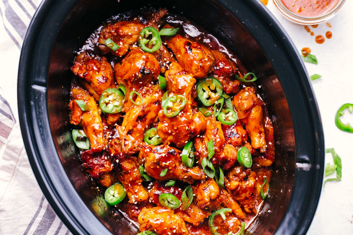 Crock pot Party wings in a crock pot with BBQ sauce and Jalapeños