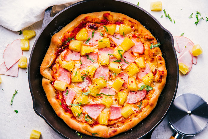 Cast iron skillet pizza with pineapple and canadian bacon on top