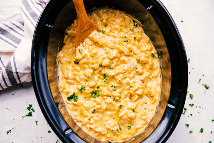 Easy crock pot mac and cheese being served out of the crock pot. 