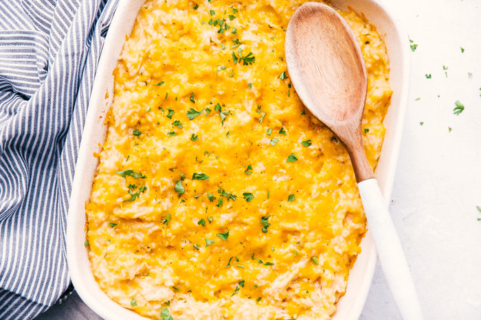 cheesy chicken and rice in a casserole dish with wooden serving spoon.-Perfect 30 minute meal. 