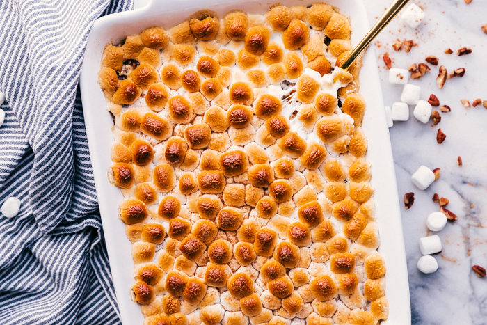 Sweet potato casserole in a white casserole dish with roasted mini marshmallows on top-holiday favorite