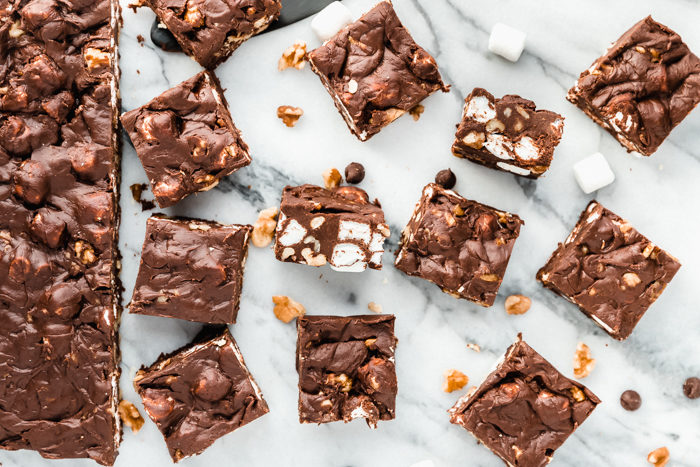 Rocky road fudge by The Food Cafe cut into squares on a white background to show the rich dark chocolate of the fudge, an easy 4 ingredient recipe.