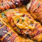 bacon wrapped chicken topped with chili cheese sauce.